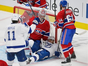 Tampa Bay Lightning right wing J.T. Brown, on ground, falls after scoring a goal against Montreal Canadiens goalie Carey Price, centre, as Lightning centre Brian Boyle, left, and Canadiens defenceman Greg Pateryn, right, look on during the third period of game two of their NHL eastern conference semi-final hockey series at the Bell Centre in Montreal on Sunday, May 3, 2015.