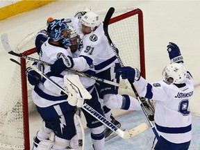 Ben Bishop (#30) of the Tampa Bay Lightning celebrates with his teammates after defeating the New York Rangers by a score of 2-0 to win Game Seven of the Eastern Conference Finals during the 2015 NHL Stanley Cup Playoffs at Madison Square Garden on May 29, 2015 in New York City.