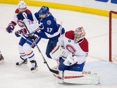 Montreal Canadiens goalie Carey Price makes a save as Tampa Bay Lightning centre Alex Killorn and Montreal Canadiens defenceman Andrei Markov fight for the rebound during the first period of Game 6 of their NHL Eastern Conference semifinal series at Amalie Arena in Tampa, Fla. on Tuesday, May 12, 2015.
