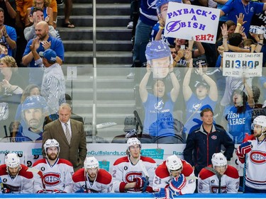 Montreal Canadiens head coach Michel Therrien, standing left, and the Canadiens bench react to the goal by Tampa Bay Lightning right wing Nikita Kucherov, not pictured, as Tampa fans cheer during the third period of Game 6 of their NHL Eastern Conference semifinal series at Amalie Arena in Tampa, Fla., on Tuesday, May 12, 2015.