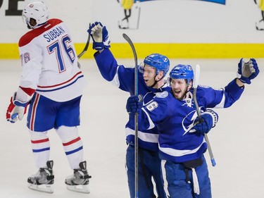 Tampa Bay Lightning right wing Nikita Kucherov, right, celebrates his goal with teammate Tampa Bay Lightning left wing Ondrej Palat, centre, as Montreal Canadiens defenseman P.K. Subban skates past during the third period of Game 6 of their NHL Eastern Conference semifinal series at Amalie Arena in Tampa, Fla., on Tuesday, May 12, 2015.