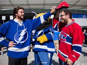 A Tampa Bay Lightning fan puts back the hat of Canadiens fan Benjamin Nadler after he tried to place it on the Bolts mascot ThunderBug outside Amalie Arena in Tampa, Fla., before the start of Game 3 of Eastern Conference semifinal series.
