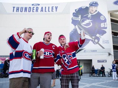 Left to right: Montreal Canadiens fans from St. John's, Newfoundland Nathan Hutchens, Jeff MacRoberts, and Alex Walsh cheer outside the Amelie Arena before the start of game three of the NHL eastern conference semi-final hockey series between the Montreal Canadiens and the Tampa Bay Lightning in Tampa on Wednesday, May 6, 2015.