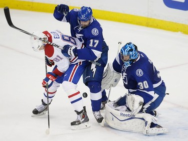 Montreal Canadiens centre Lars Eller, left, fights for the puck against Tampa Bay Lightning centre Alex Killorn, centre, and Lightning goalie Ben Bishop, right, during the second period of game three of their NHL eastern conference semi-final hockey series at Amalie Arena in Tampa on Wednesday, May 6, 2015.