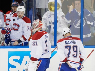 Montreal Canadiens goalie Carey Price, centre, and teammate Andrei Markov, right, skate towards the bench after losing game three of their NHL eastern conference semi-final hockey series against Tampa Bay Lightning at Amalie Arena in Tampa on Wednesday, May 6, 2015.
