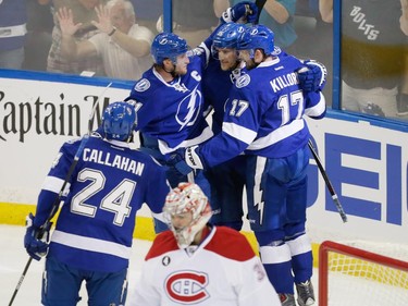 Tampa Bay Lightning centre Alex Killorn, top right, celebrates his goal with teammates as Montreal Canadiens goalie Carey Price, bottom, skates past during the first period of game three of their NHL eastern conference semi-final hockey series at Amalie Arena in Tampa on Wednesday, May 6, 2015.