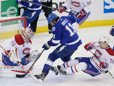Tampa Bay Lightning centre Brian Boyle, centre, attempts a shot against Montreal Canadiens goalie Carey Price, left, as Canadiens defenceman Alexei Emelin, right, falls during the second period of game three of their NHL eastern conference semi-final hockey series at Amalie Arena in Tampa on Wednesday, May 6, 2015.