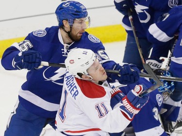 Tampa Bay Lightning defenceman Braydon Coburn, top, crosschecks Montreal Canadiens right wing Brendan Gallagher, bottom, during the first period of game three of their NHL eastern conference semi-final hockey series at Amalie Arena in Tampa on Wednesday, May 6, 2015.