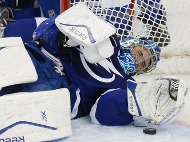 Tampa Bay Lightning goalie Ben Bishop falls after making a save against the Montreal Canadiens during the second period of game three of their NHL eastern conference semi-final hockey series at Amalie Arena in Tampa on Wednesday, May 6, 2015.