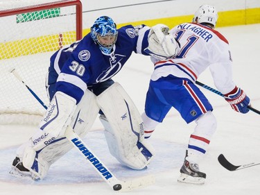 Tampa Bay Lightning goalie Ben Bishop, left, makes a save against Montreal Canadiens right wing Brendan Gallagher, right, during the third period of game three of their NHL eastern conference semi-final hockey series at Amalie Arena in Tampa on Wednesday, May 6, 2015.