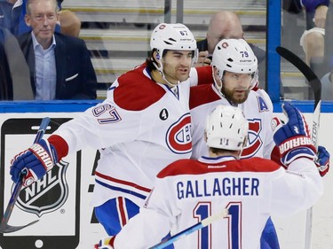 Montreal Canadiens defenceman Andrei Markov, right, celebrates his goal with teammate Max Pacioretty, left, and Brendan Gallagher, bottom, during the first period of game four of their NHL eastern conference semi-final hockey series against the Tampa Bay Lightning at Amalie Arena in Tampa on Thursday, May 7, 2015.
