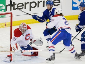 Montreal Canadiens goalie Carey Price, left, makes a save against Tampa Bay Lightning centre Tyler Johnson, centre, as Montreal Canadiens defenceman Jeff Petry, right, attempts to to block during the second period of game four of their NHL eastern conference semi-final hockey series at Amalie Arena in Tampa on Thursday, May 7, 2015.