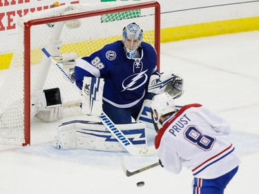 Montreal Canadiens right wing Brandon Prust, bottom attempts a shot against Tampa Bay Lightning goalie Andrei Vasilevskiy, top, during the third period of game four of their NHL eastern conference semi-final hockey series at Amalie Arena in Tampa on Thursday, May 7, 2015.