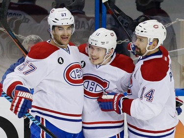 Montreal Canadiens right wing Brendan Gallagher, centre, celebrates his goal with teammates Max Pacioretty, left, and Tomas Plekanec, right, as the Canadiens faced the Tampa Bay Lightning at Amalie Arena in Tampa on May 7, 2015.