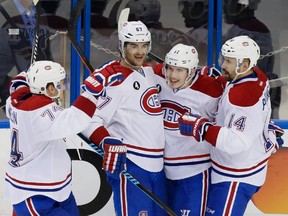 Montreal Canadiens right wing Brendan Gallagher, centre, celebrates his goal with teammates Alexei Emelin, left, Max Pacioretty, second from left, and Tomas Plekanec, right, during the second period of game four of their NHL eastern conference semi-final hockey series against the Tampa Bay Lightning at Amalie Arena in Tampa on Thursday, May 7, 2015.