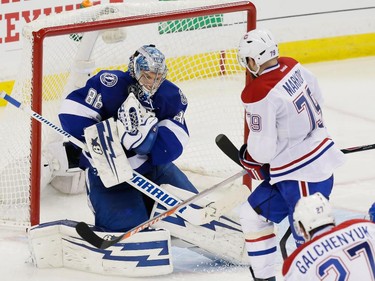 Tampa Bay Lightning goalie Andrei Vasilevskiy, left, makes a save against Montreal Canadiens defenceman Andrei Markov, right, during the third period of game four of their NHL eastern conference semi-final hockey series at Amalie Arena in Tampa on Thursday, May 7, 2015.