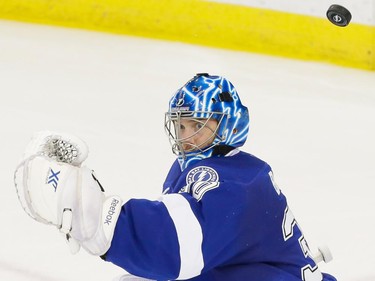 The puck flies past Tampa Bay Lightning goalie Ben Bishop as he is scored on by Montreal Canadiens centre David Desharnais, not pictured, during the second period of game four of their NHL eastern conference semi-final hockey series at Amalie Arena in Tampa on Thursday, May 7, 2015.