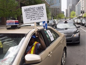 Taxi drivers hold a demonstration through the streets of downtown against the ride-sharing app Uber Tuesday, May 19, 2015 in Montreal.