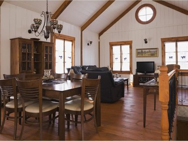 The dining  and living room area in the extension is very cosy and bright thanks to windows on three sides that reflect the light off the white walls.