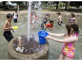 TORONTO, ONTARIO: JULY 4, 2012 -- HOT WEATHER -- Children keep cool by playing in the splash pad at MacGregor Park in Toronto Wednesday, July 4, 2012. The mercury rose above 40 degrees celsius with the humidex on Wednesday as a heat wave continued to keep temperatures above average in Toronto.   (Darren Calabrese/National Post)  [For Toronto] //NATIONAL POST STAFF PHOTO