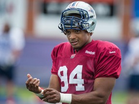 Michael Sam puts on a "MU Pride" bracelet from the University of Missouri's student association for the LGBTQ community, as he takes part in the Alouettes' rookie camp.