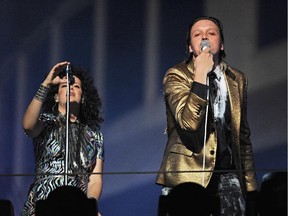 Arcade Fire performs outside the iconic Capitol Records building in Hollywood, California October 29, 2013.  Arcade Fire, led by Win Butler (R) and Régine Chassagne (L),  staged an impromptu concert to mark the release of their new album Reflektor.