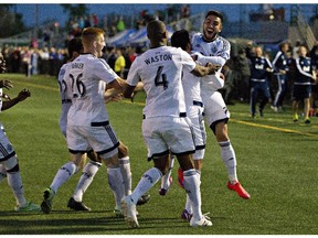 Vancouver Whitecaps celebrate their win over the Edmonton FC during the Amway Canadian Championship semifinal in Edmonton, Alta., on Wednesday May 20, 2015.