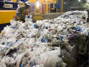 Worker secures plastic bag  bundles at the Montreal recycling plant on November 25, 2008. (THE GAZETTE/ Pierre Obendrauf)