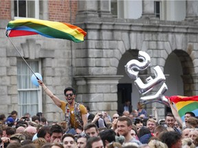 Yes supporters celebrate at Dublin castle, Ireland, Saturday, May 23, 2015. Ireland has voted resoundingly to legalize gay marriage in the world's first national vote on the issue, leaders on both sides of the Irish referendum declared Saturday even as official ballot counting continued. Senior figures from the "no" campaign, who sought to prevent Ireland's constitution from being amended to permit same-sex marriages, say the only question is how large the "yes" side's margin of victory will be from Friday's vote.