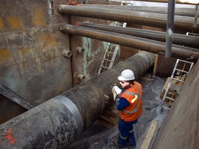 Michael Audet stands next to Enbridge 9b oil pipeline in 2013.
