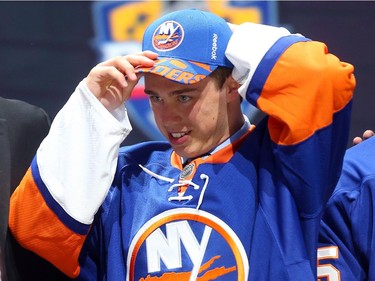 Anthony Beauvillier puts on his hat after being selected 28th overall by the New York Islanders in the first round of the 2015 NHL Draft on June 26, 2015 in Sunrise, Florida.