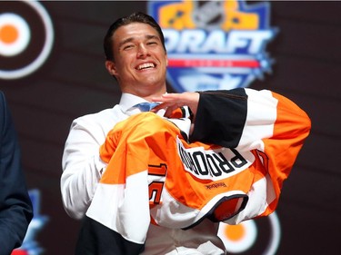 Ivan Provorov puts on his jersey after being selected seventh overall by the Philadelphia Flyers in the first round of the 2015 NHL Draft on June 26, 2015 in Sunrise, Florida.