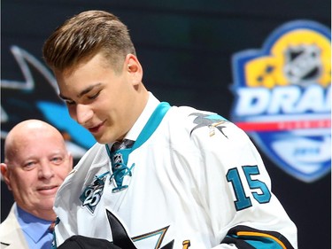 Timo Meier puts on his hat after being selected ninth overall by the San Jose Sharks in the first round of the 2015 NHL Draft on June 26, 2015 in Sunrise, Florida.