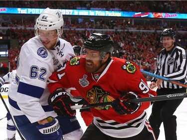 Brad Richards #91 of the Chicago Blackhawks and Andrej Sustr #62 of the Tampa Bay Lightning battle for the puck in the first period during Game Four of the 2015 NHL Stanley Cup Final at the United Center on June 10, 2015 in Chicago, Illinois.