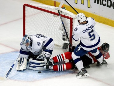 Jason Garrison #5 of the Tampa Bay Lightning checks Jonathan Toews #19 of the Chicago Blackhawks into the net during Game Four of the 2015 NHL Stanley Cup Final at the United Center on June 10, 2015 in Chicago, Illinois.