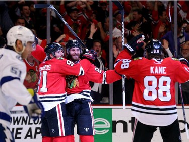 Brandon Saad #20 celebrates with Brad Richards #91 and Patrick Kane #88 of the Chicago Blackhawks after scoring a goal in the third period against the Tampa Bay Lightning during Game Four of the 2015 NHL Stanley Cup Final at the United Center on June 10, 2015 in Chicago, Illinois.