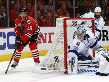 Jonathan Toews #19 of the Chicago Blackhawks looks to pass from behind the net against the Tampa Bay Lightning during Game Four of the 2015 NHL Stanley Cup Final at the United Center on June 10, 2015 in Chicago, Illinois.