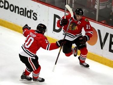 Jonathan Toews #19 celebrates his second period goal with Patrick Sharp #10 of the Chicago Blackhawks against the Tampa Bay Lightning during Game Four of the 2015 NHL Stanley Cup Final at the United Center on June 10, 2015 in Chicago, Illinois.