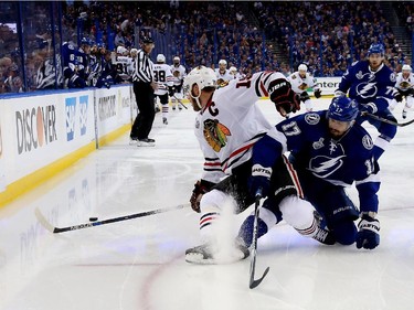 Alex Killorn (#17) of the Tampa Bay Lightning collides with Jonathan Toews (#19) of the Chicago Blackhawks during the first period in Game One of the 2015 NHL Stanley Cup Final at Amalie Arena on June 3, 2015 in Tampa, Florida.