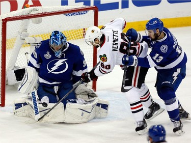 Ben Bishop #30 of the Tampa Bay Lightning makes a save in the first period against Antoine Vermette #80 of the Chicago Blackhawks during Game One of the 2015 NHL Stanley Cup Final at Amalie Arena on June 3, 2015 in Tampa, Florida.