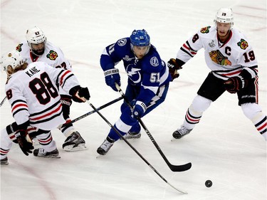 Valtteri Filppula #51 of the Tampa Bay Lightning controls the puck as Jonathan Toews #19 of the Chicago Blackhawks defends during Game One of the 2015 NHL Stanley Cup Final at Amalie Arena on June 3, 2015 in Tampa, Florida.