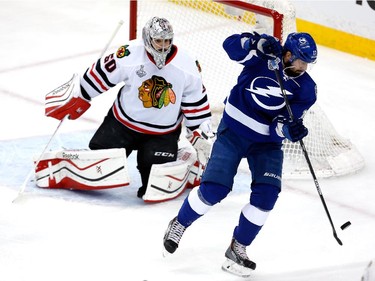 Alex Killorn #17 of the Tampa Bay Lightning scores a first period goal against Corey Crawford #50 of the Chicago Blackhawks during Game One of the 2015 NHL Stanley Cup Final at Amalie Arena on June 3, 2015 in Tampa, Florida.