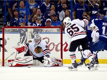 Corey Crawford #50 of the Chicago Blackhawks makes a save against the Tampa Bay Lightning in the first period during Game One of the 2015 NHL Stanley Cup Final at Amalie Arena on June 3, 2015 in Tampa, Florida.