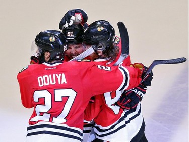 Patrick Kane #88 of the Chicago Blackhawks celebrates with teammates Johnny Oduya #27 and Brad Richards #91 after scoring a goal in the third period against the Tampa Bay Lightning during Game Six of the 2015 NHL Stanley Cup Final at the United Center  on June 15, 2015 in Chicago, Illinois.