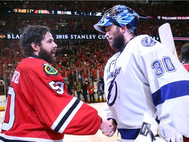 Corey Crawford #50 of the Chicago Blackhawks shakes hands with Ben Bishop #30 of the Tampa Bay Lightning after the Blackhawks won Game Six by a score of 2-0 to win the 2015 NHL Stanley Cup Final at the United Center  on June 15, 2015 in Chicago, Illinois.