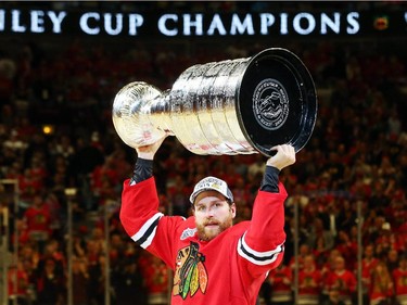Kimmo Timonen #44 of the Chicago Blackhawks celebrates by hoisting the Stanley Cup after defeating the Tampa Bay Lightning  by a score of 2-0 in Game Six to win the 2015 NHL Stanley Cup Final at the United Center  on June 15, 2015 in Chicago, Illinois.