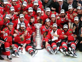 The Chicago Blackhawks pose with the Stanley Cup after defeating the Tampa Bay Lightning  by a score of 2-0 in Game Six to win the 2015 NHL Stanley Cup Final at the United Center  on June 15, 2015 in Chicago, Illinois.