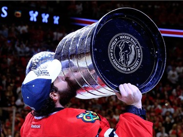 Corey Crawford #50 of the Chicago Blackhawks celebrates by kissing the Stanley Cup after defeating the Tampa Bay Lightning  by a score of 2-0 in Game Six to win the 2015 NHL Stanley Cup Final at the United Center  on June 15, 2015 in Chicago, Illinois.
