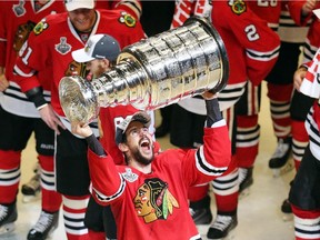 Antoine Vermette #80 of the Chicago Blackhawks celebrates by hoisting the Stanley Cup after defeating the Tampa Bay Lightning  by a score of 2-0 in Game Six to win the 2015 NHL Stanley Cup Final at the United Center  on June 15, 2015 in Chicago, Illinois.