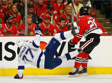Brandon Saad #20 of the Chicago Blackhawks collides with Victor Hedman #77 of the Tampa Bay Lightning during Game Six of the 2015 NHL Stanley Cup Final at the United Center  on June 15, 2015 in Chicago, Illinois.